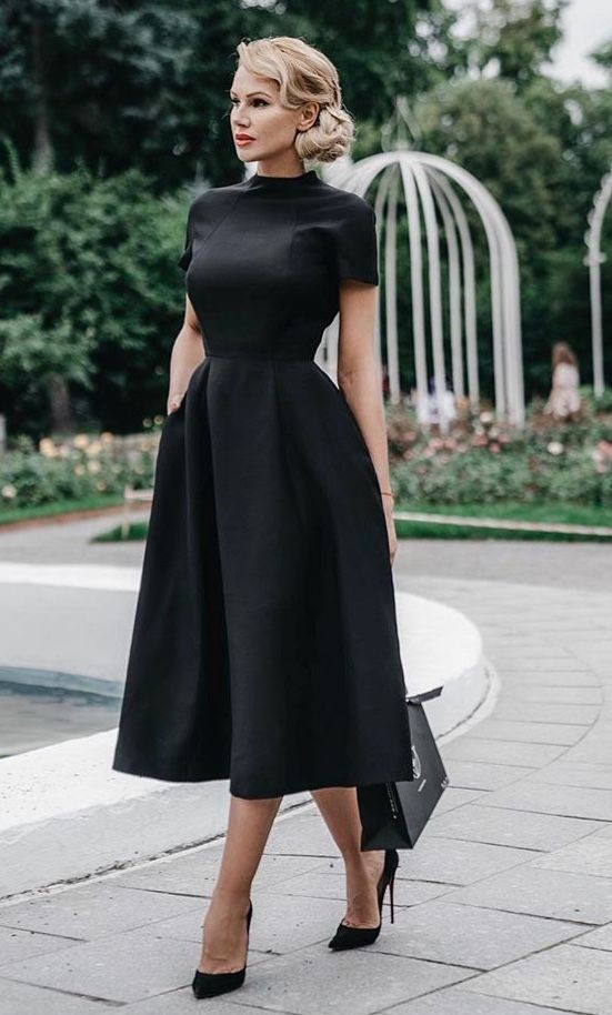 A woman wearing a black dress
