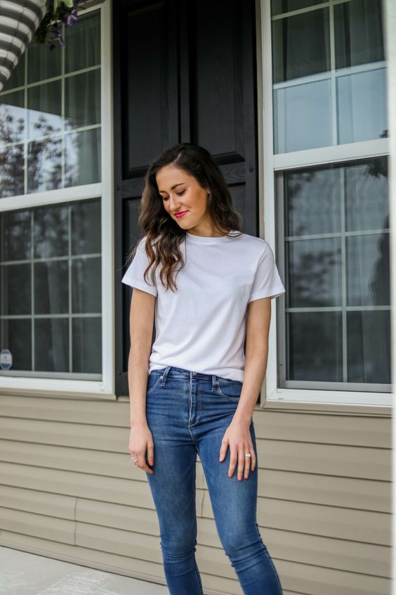 a woman wearing a White Tee and Jeans